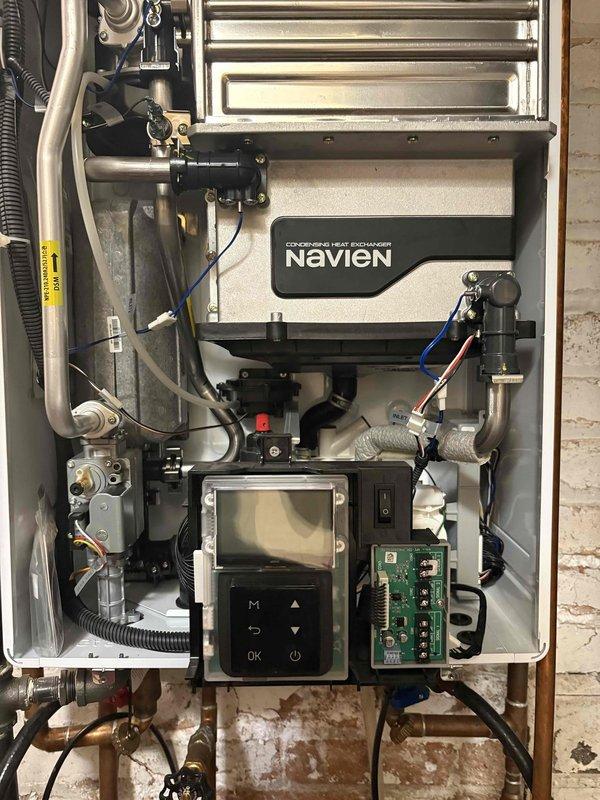 Performed routine maintenance flush on Navien condensing tankless water heater unit. Accessed internal components, isolated system, and executed descaling procedure using submersible pump and cleaning solution to remove mineral deposits from heat exchanger. Unit tested and confirmed operating properly upon completion.