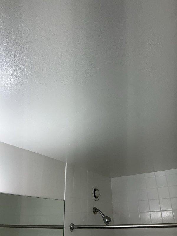 Responded to a water leak investigation request for a high-rise bathroom unit where a home inspector had identified possible moisture on the ceiling. Conducted a thorough inspection of the bathroom ceiling, shower area, and plumbing fixtures to determine the source of reported moisture concerns. Examined the ceiling surfaces for active water intrusion, staining patterns, or structural damage that would indicate a plumbing leak from above. Inspected all visible plumbing connections, including shower valve assembly, shower arm, handheld shower fixture, and associated supply lines for signs of leakage or seepage. Evaluated the bathroom ventilation system, including the exhaust fan operation and ductwork accessibility, to assess whether inadequate ventilation could be contributing to moisture accumulation. Checked the shower enclosure integrity, including glass panel seals and threshold waterproofing, to rule out water escaping the shower area during use. Assessed tile grout condition and 