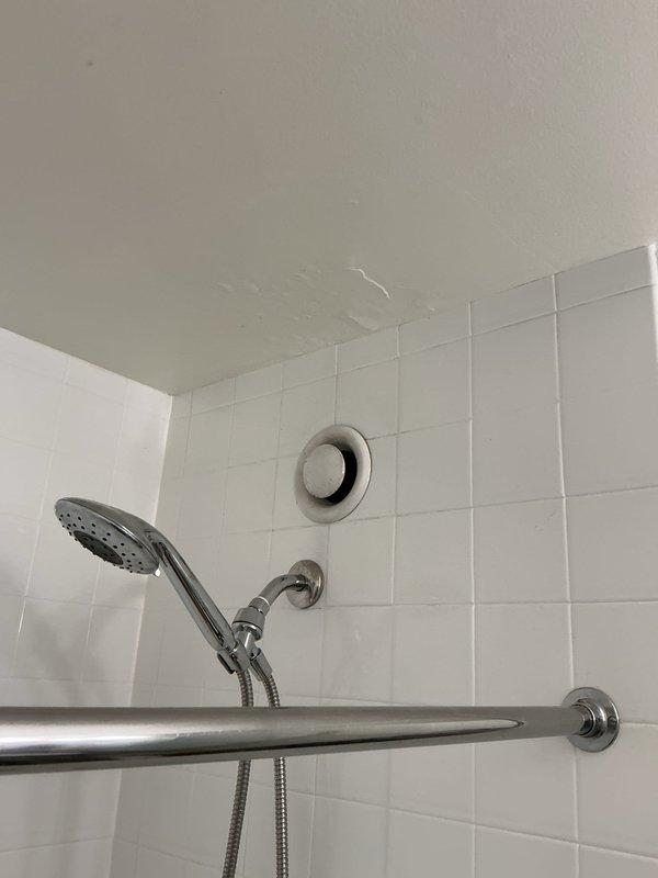 Responded to a water leak investigation request for a high-rise bathroom unit where a home inspector had identified possible moisture on the ceiling. Conducted a thorough inspection of the bathroom ceiling, shower area, and plumbing fixtures to determine the source of reported moisture concerns. Examined the ceiling surfaces for active water intrusion, staining patterns, or structural damage that would indicate a plumbing leak from above. Inspected all visible plumbing connections, including shower valve assembly, shower arm, handheld shower fixture, and associated supply lines for signs of leakage or seepage. Evaluated the bathroom ventilation system, including the exhaust fan operation and ductwork accessibility, to assess whether inadequate ventilation could be contributing to moisture accumulation. Checked the shower enclosure integrity, including glass panel seals and threshold waterproofing, to rule out water escaping the shower area during use. Assessed tile grout condition and 