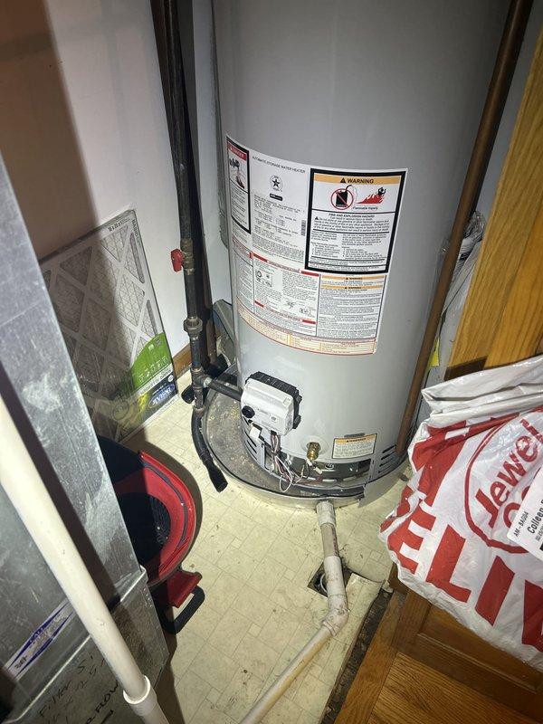 Responded to active water leak in unoccupied rental unit. Upon arrival, conducted thorough inspection of water heater and surrounding utility area as reported by property owner. Examined gas water heater installation, including tank condition, control valve assembly, supply lines, and drain pan area. Inspected ceiling and walls in adjacent spaces for signs of water intrusion, noting visible moisture indicators at ceiling vent location. Documented all findings with photographic evidence showing water heater installation and affected ceiling areas. Identified source of leak and provided property owner with assessment of necessary repairs and recommendations for resolution.