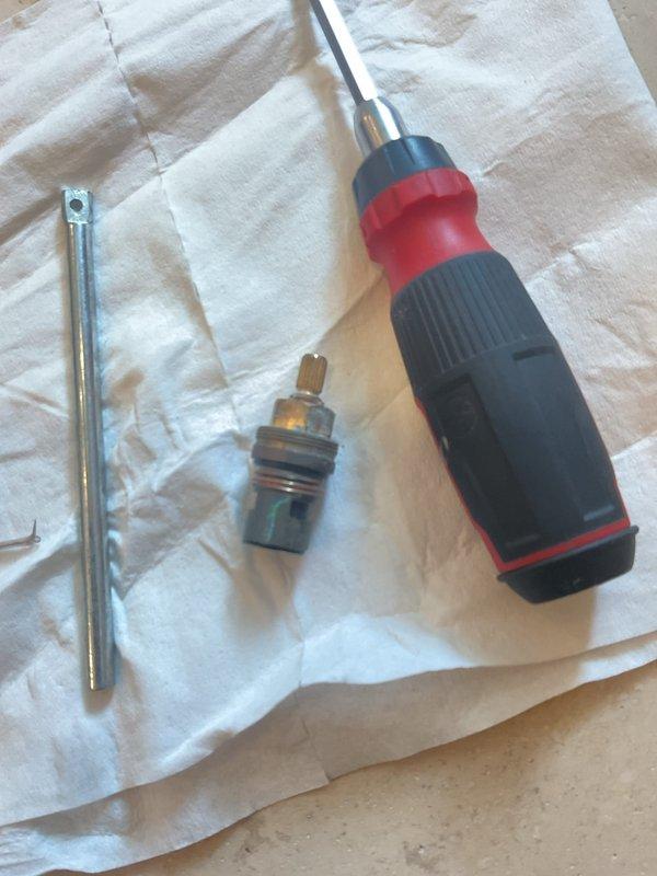 Responded to dripping shower complaint and successfully diagnosed faulty cartridge assembly. Removed and replaced worn brass valve cartridge and stem assembly from shower fixture, restoring proper water flow control and eliminating leak. Verified operation of ceiling-mounted shower head upon completion, with fixture now functioning properly without dripping.