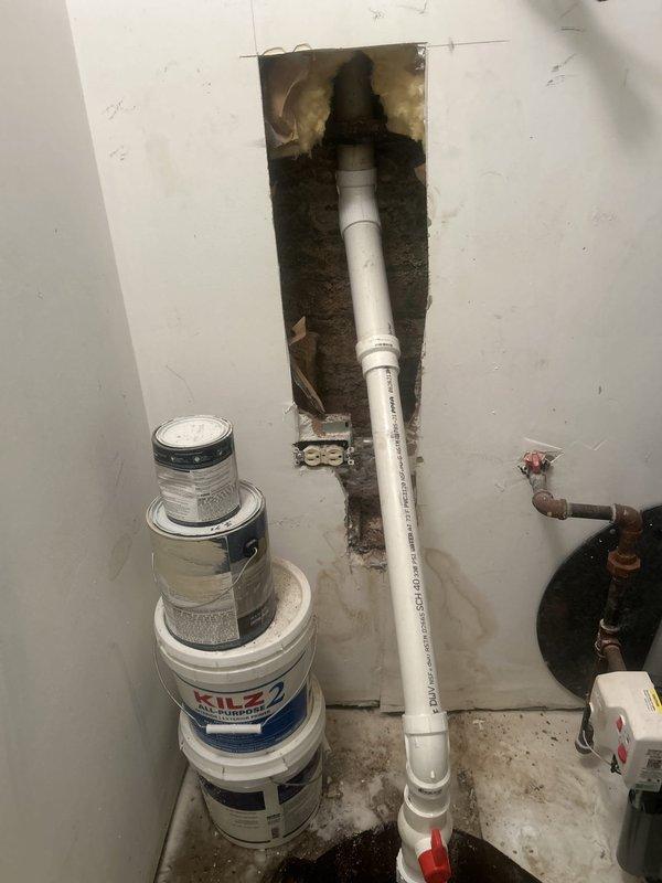 Responded to emergency call for leaking sump pump in utility room. Upon arrival, found existing sump pump of unknown age actively leaking and failing to operate properly, with visible water damage and staining on concrete floor around basin. Assessed system and determined pump had reached end of service life and required immediate replacement to prevent flooding. Removed failed submersible pump from basin, inspected discharge piping and check valve for proper operation, and installed new green submersible sump pump with appropriate horsepower rating for residential application. Verified all PVC discharge connections were secure and tested pump cycling operation to ensure proper activation at correct water levels. System now functioning correctly with no leaks detected.