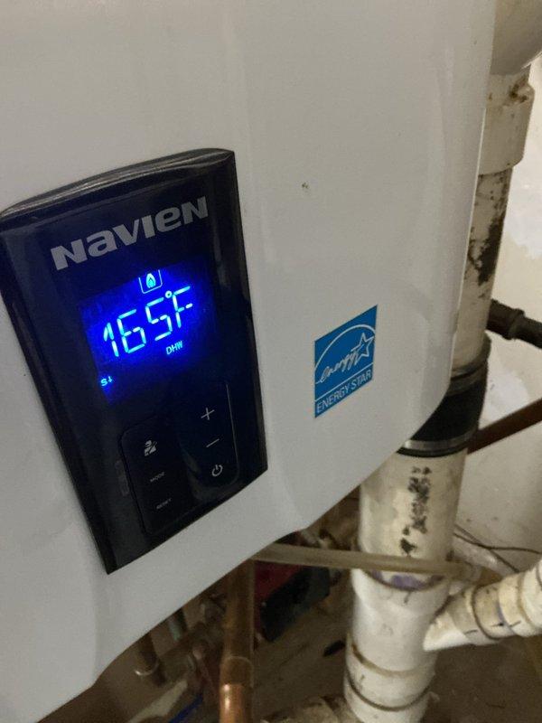 Responded to service call for no hot water issue at residential property. Upon arrival, inspected Navien tankless water heater and existing tank-style water heater system. Verified Navien unit was displaying 165°F on digital control panel with DHW indicator illuminated, confirming unit was receiving power and attempting to operate. Examined all plumbing connections, including PVC and copper piping, pressure relief valves, and shut-off valves on both units. Troubleshot system to identify cause of hot water delivery failure, checking for potential issues with temperature settings, flow restrictions, or equipment malfunction. Documented equipment conditions and system configuration with photographs for service records.