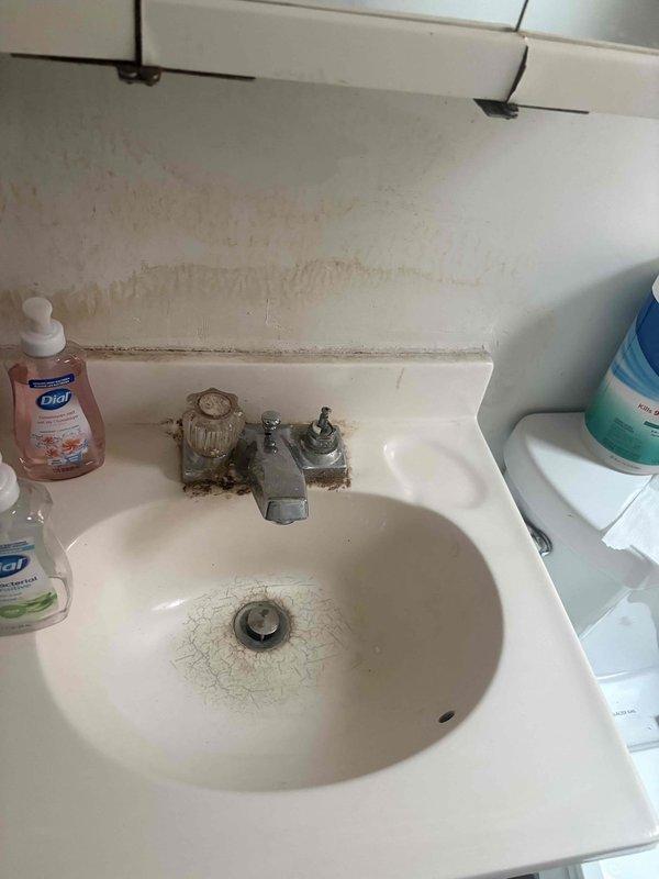 Conducted plumbing estimate for installation of water supply lines to accommodate second-floor laundry facilities where no existing plumbing infrastructure is present, and assessed kitchen dishwasher installation requirements. Documented current bathroom fixtures showing signs of water damage, mineral deposits, and deteriorated finishes to evaluate overall plumbing system condition prior to planned expansion work.