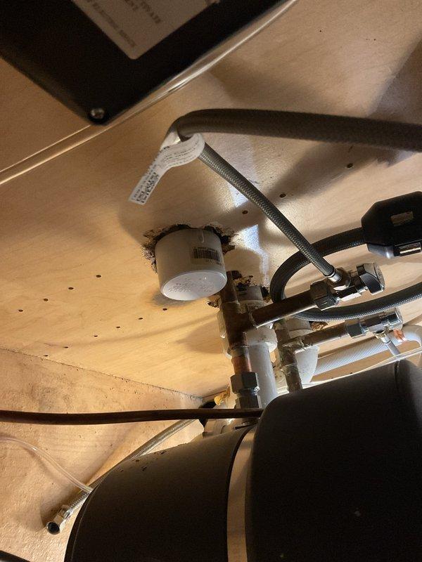 Completed estimate for replacement of deteriorated under-sink water shut-off valves. Inspection revealed corroded angle stops with mineral buildup and debris accumulation around drain assembly, along with staining at pipe penetrations indicating age-related deterioration of existing fixtures. Documented existing plumbing configuration including supply lines, drain connections, and cabinet accessibility for replacement recommendations.