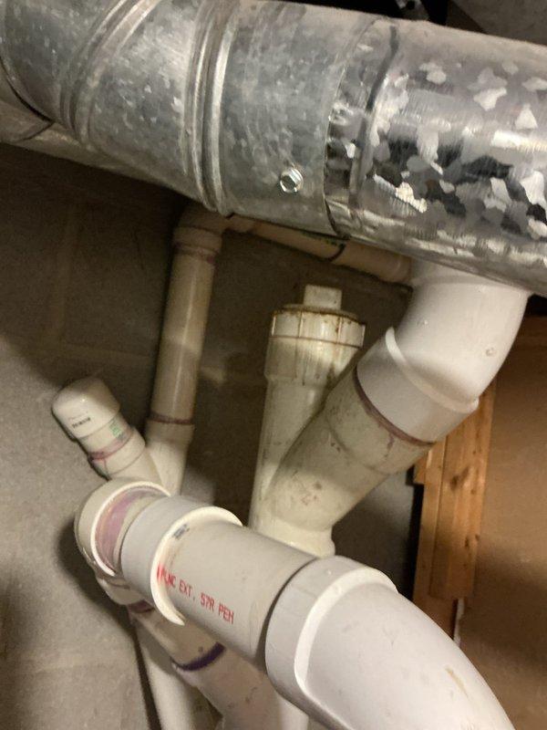 Responded to complaint of strong sewer smell emanating from toilet fixture. Inspected drainage system and discovered dry trap condition in basement plumbing infrastructure. Located affected drain line connected to fixture and verified proper venting configuration. Tested all drain connections under kitchen sink and verified garbage disposal installation for potential cross-contamination issues. Ran water through system to recharge P-trap and restore proper water seal. Confirmed elimination of sewer gas odor and verified all plumbing connections were secure and functioning correctly.