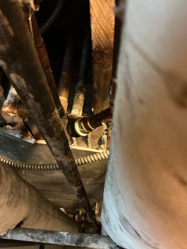 Responded to complaint of no hot water at kitchen and bathroom sinks while shower maintained proper hot water temperature following recent water heater replacement. Investigated plumbing infrastructure in confined mechanical space and inspected supply line connections beneath fixtures. Examined braided stainless steel flexible supply lines, shut-off valves, and connection points at affected fixtures. Assessed water heater installation and distribution system to identify cause of inconsistent hot water delivery to specific fixtures while other outlets functioned properly.