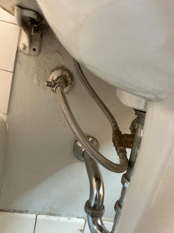 Responded to complaint of no hot water at kitchen and bathroom sinks while shower maintained proper hot water temperature following recent water heater replacement. Investigated plumbing infrastructure in confined mechanical space and inspected supply line connections beneath fixtures. Examined braided stainless steel flexible supply lines, shut-off valves, and connection points at affected fixtures. Assessed water heater installation and distribution system to identify cause of inconsistent hot water delivery to specific fixtures while other outlets functioned properly.