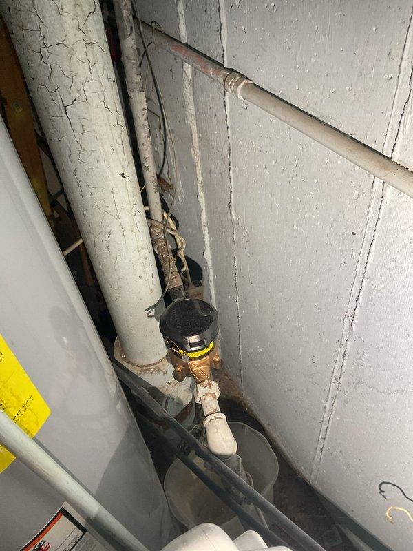 Inspected plumbing system and wall-mounted utility access point. Documented existing conditions including aged mechanical infrastructure with deteriorated pipe insulation, pressure relief valve assembly, and multiple water supply lines. Return visit scheduled to complete additional work per customer request.