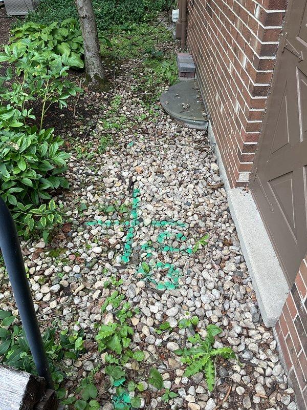 Responded to a reported broken sewer line at a residential property for inspection and assessment. Upon arrival, conducted a thorough examination of the existing cast iron plumbing system in the basement utility area and exterior sewer access points along the side of the building. Inspected the main sewer line configuration, pipe connections, and drainage system components to identify the source and extent of the failure. Documented conditions of the plumbing infrastructure including the cast iron waste stack, pipe joints, and exterior access areas where markers indicated potential excavation or repair zones. Provided the homeowner with findings from the inspection and recommendations for necessary repairs to restore proper sewer line function.