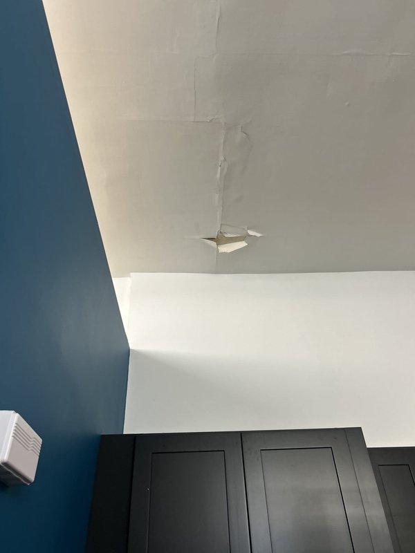 Responded to service call for multiple water leaks, including chronic ceiling leak originating from upstairs bathroom. Performed visual inspection and documentation of three reported leak locations. Identified active water damage on ceiling with visible cracking, peeling material, and structural deterioration above cabinetry. Inspected upstairs bathroom floor area where hexagonal tile meets bathtub/shower base, noting deteriorated grout lines, tile discoloration, and erosion at fixture junction indicating potential water intrusion point. Documented all affected areas with photographic evidence for further evaluation and repair recommendations.