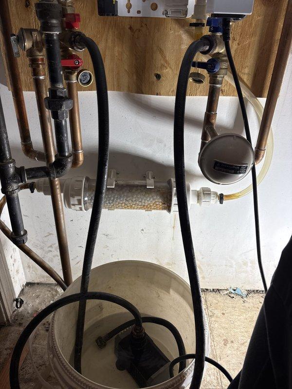Completed annual maintenance service on Navien tankless water heater system under existing service contract. Performed comprehensive system flush to remove mineral buildup and sediment accumulation from heat exchanger and internal components. Inspected all plumbing connections, copper and brass piping, valves, and flexible hoses for signs of wear or leakage. Verified proper operation of pressure relief valve, circulation system components, and water filtration housing with media cartridge. Tested digital control interface functionality and reviewed system diagnostics through onboard LCD display. Confirmed all pressure gauges reading within normal operating parameters. System operating efficiently with no issues detected upon completion of service.