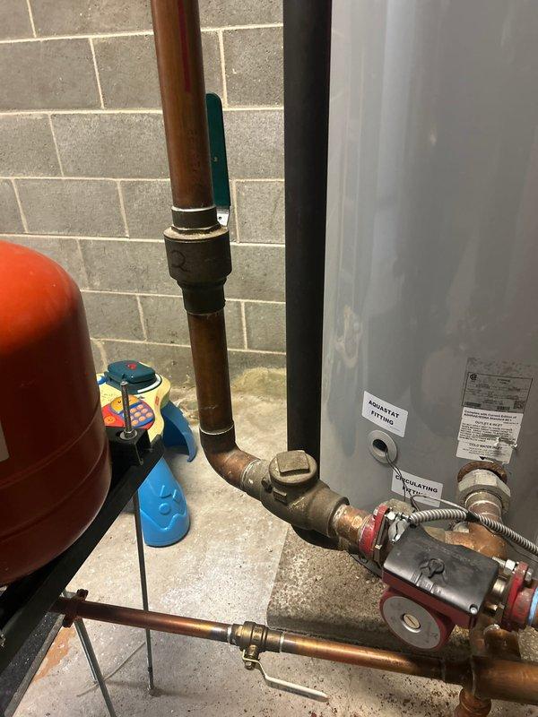 Responded to a service call for residential plumbing system evaluation. Upon inspection of the basement mechanical room, assessed the existing heating system, water heater, and associated plumbing infrastructure. The system includes a wall-mounted heating unit with ductwork, a standard residential water heater, and a red expansion tank with supporting plumbing connections.

Examined the condition of copper and galvanized piping throughout the system, noting age-related patina and oxidation on various components. Inspected all visible valves, gauges, pressure relief mechanisms, and brass fittings for proper operation and potential concerns. Documented the current state of the mechanical equipment including pipe connections, flexible hoses, and safety devices attached to both the heating unit and water heater.

Provided professional assessment and recommendations to the customer regarding the plumbing system's condition. Customer approved proposed repair work, and sale was successfully c