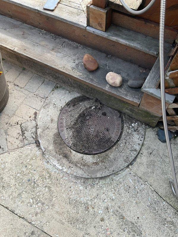 Responded to a sewer rodding service call and successfully cleared the main drain line through the exterior cleanout access point located in the concrete patio area. Upon arrival, removed the metal cleanout cover, deployed the cable rodding equipment through the access point, and thoroughly cleared any blockages or buildup in the mainline to restore proper drainage flow.