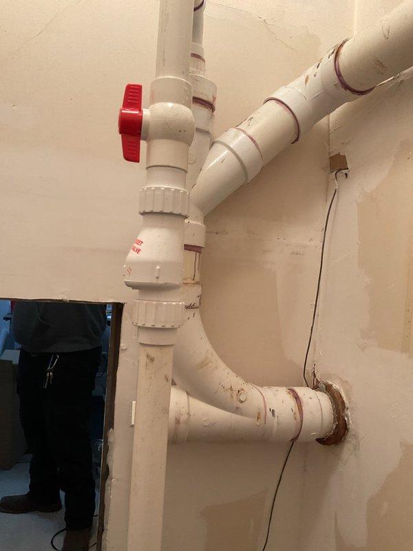 Installed new submersible sump pump system with complete discharge piping assembly. Connected PVC discharge lines with check valve and shutoff valve for proper water removal and system control, ensuring reliable basement water management and protection against flooding.