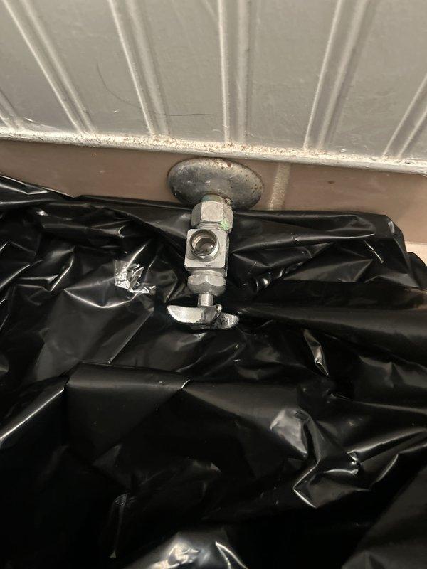 Responded to emergency building shutdown at 8:00 AM to address critical plumbing issue. Upon arrival, inspected bathroom fixtures and accessed overhead piping through ceiling access point. Identified failed pipe fitting assembly requiring immediate replacement to restore water service. Shut down water supply to affected area, removed deteriorated galvanized pipe fitting and mounting flange from ceiling connection point. Installed protective plastic sheeting to contain water damage and debris during repair work. Replaced faulty pipe assembly with new chrome-plated fitting, ensuring proper seal at ceiling penetration. Tested system for leaks, verified water pressure, and confirmed full restoration of plumbing service to bathroom fixtures including toilet, bathtub, and vanity. Building water service successfully restored and brought back online.