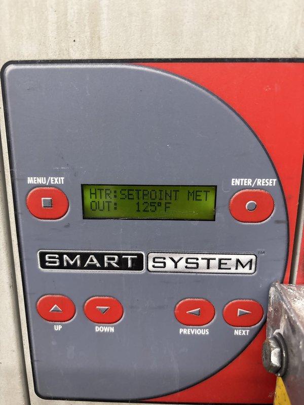 Completed water heater control system repair and diagnostic service. Verified SMART SYSTEM control panel operation showing heater setpoint met with output temperature reading 125°F. Inspected internal electrical components, circuit board connections, and wiring harness for proper operation and safety compliance. All control functions including menu navigation, temperature adjustment buttons, and system reset capabilities tested and confirmed operational.