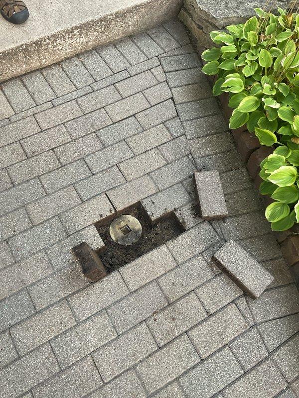 Technicians accessed the main sewer line through an exterior cleanout located beneath paver stones in the outdoor walkway area. A mechanical rod was deployed through the cleanout to clear a blockage that was obstructing wastewater flow to the residence. Following successful removal of the obstruction, a camera inspection was performed through the sewer line to assess pipe condition and identify any structural deficiencies or additional concerns requiring further evaluation by the sewer supervisor.