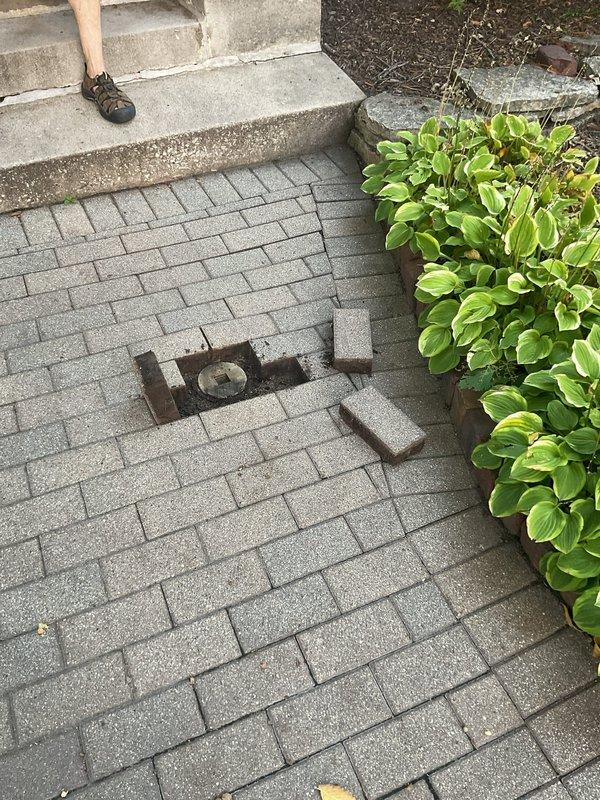 Technicians accessed the main sewer line through an exterior cleanout located beneath paver stones in the outdoor walkway area. A mechanical rod was deployed through the cleanout to clear a blockage that was obstructing wastewater flow to the residence. Following successful removal of the obstruction, a camera inspection was performed through the sewer line to assess pipe condition and identify any structural deficiencies or additional concerns requiring further evaluation by the sewer supervisor.