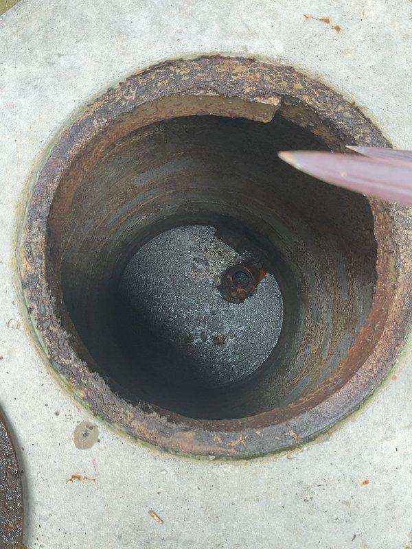 Performed high-pressure jetting service on catch basin installed in 2020 that had never been previously maintained. Accessed the basin through outdoor patio opening, removed rusted metal cover, and deployed jetter equipment into the cylindrical cavity. Successfully cleared accumulated debris and buildup from interior walls and drainage system using hydro-jetting techniques. Basin showed significant rust and corrosion throughout metal components but structural integrity remained intact. Completed thorough cleaning of drainage pathway to restore proper flow capacity and prevent future blockages.