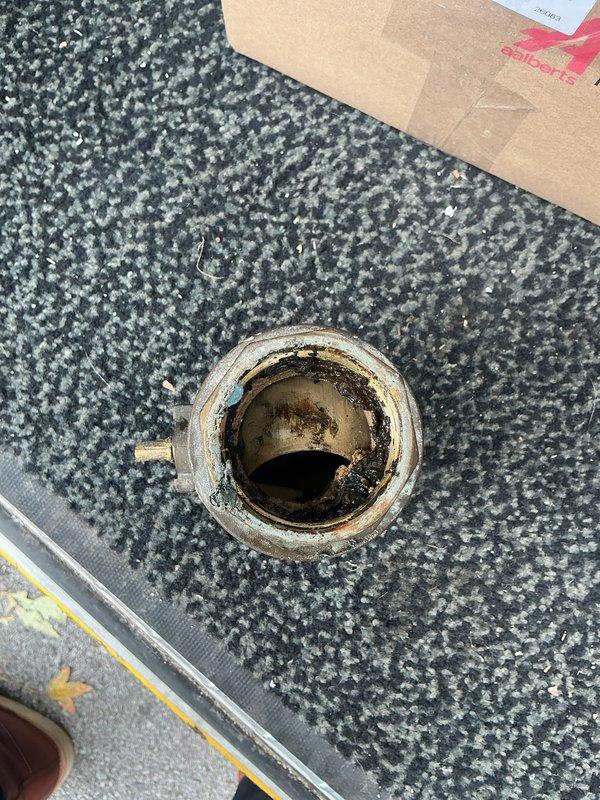 Replaced main water valve assembly on building water supply line. Shut off water supply to building using Buffalo Key prior to valve replacement. Removed old brass valve showing signs of age and mineral deposits, then installed new valve assembly with proper fittings connecting galvanized and copper pipe sections. Verified all connections were secure and tested system for proper operation and leaks upon water restoration.