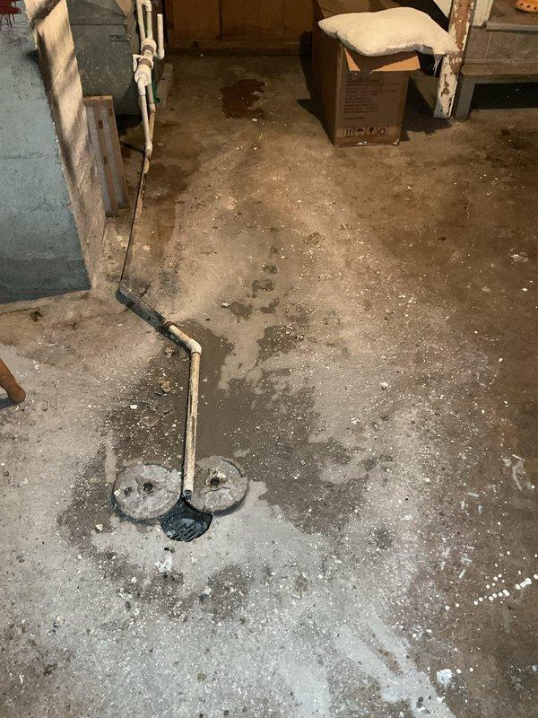 Responded to service call for water backing up through basement floor drain. Upon inspection, found catch basin with significant deterioration, rust, and corrosion throughout interior walls, with standing water and debris accumulation at bottom. Documented existing conditions and provided estimate for catch basin cleaning services to address drainage issue and prevent further basement water infiltration.