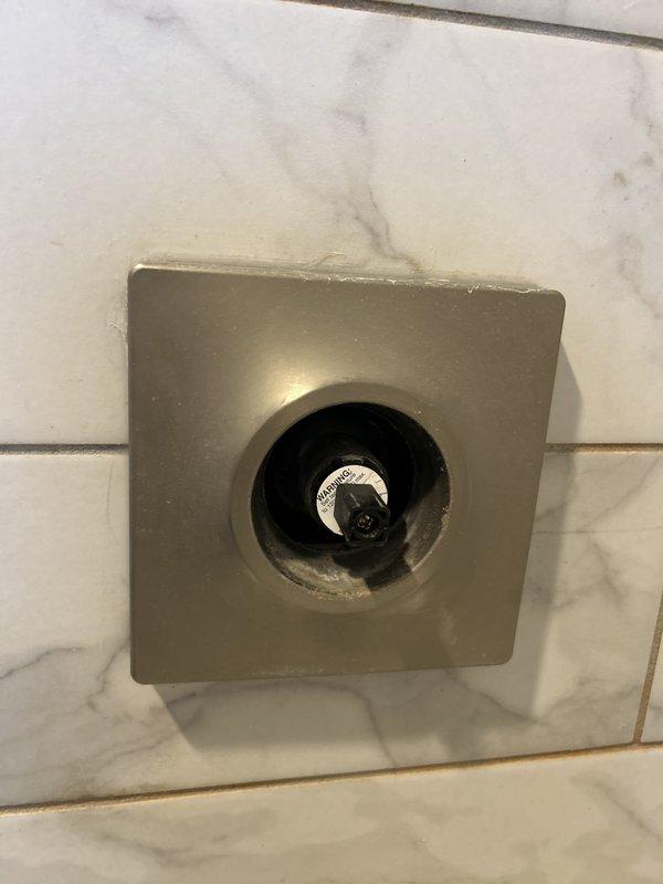 Responded to service call for continuously leaking bathtub faucet. Upon inspection, identified issue with wall-mounted tub spout and single-handle control valve assembly in bronze finish. Accessed shut-off valve behind square escutcheon plate, replaced faulty internal cartridge components, and tested for proper water flow and complete shut-off. Leak successfully resolved, fixture restored to normal operation.