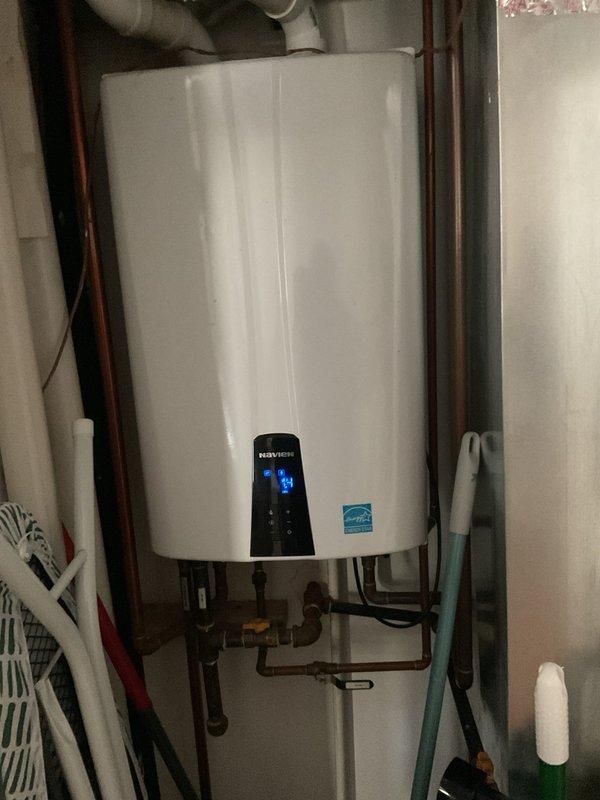 Responded to service call for Navien tankless water heater displaying error code 438. Upon arrival, inspected unit and verified error code on digital display panel. Performed diagnostic evaluation of the system, examining all connections, gas lines, copper water supply lines, and venting components. Documented current operating conditions with unit showing temperature readings on front display panel. Assessed installation including mounting bracket, shut-off valves, inlet/outlet connections, and PVC ventilation system for proper configuration and potential issues related to error code.