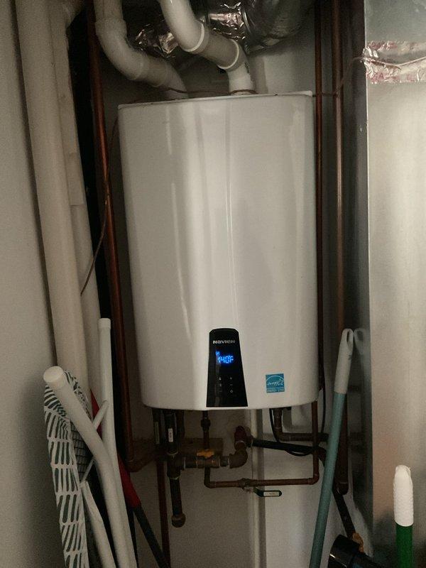 Responded to service call for Navien tankless water heater displaying error code 438. Upon arrival, inspected unit and verified error code on digital display panel. Performed diagnostic evaluation of the system, examining all connections, gas lines, copper water supply lines, and venting components. Documented current operating conditions with unit showing temperature readings on front display panel. Assessed installation including mounting bracket, shut-off valves, inlet/outlet connections, and PVC ventilation system for proper configuration and potential issues related to error code.