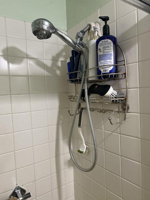 Responded to emergency service call for non-functional shower tub diverter preventing shower use. Upon inspection, found the pull-up diverter tab on the tub spout was inoperable, leaving only bathtub function available. Assessed the chrome tub spout assembly and diverter mechanism for mechanical failure. Replaced the defective tub spout diverter assembly with new chrome fixture, restoring proper water flow diversion between tub faucet and handheld showerhead. Tested operation multiple times to ensure smooth transition between tub and shower modes with no leaks or water pressure issues. Shower fully restored to working condition.