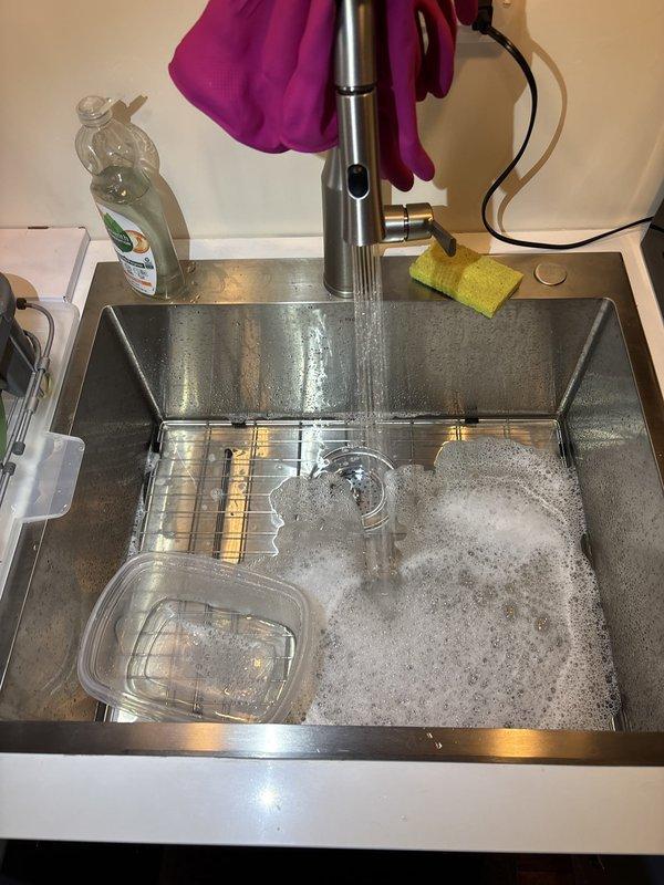 Responded to warranty callback for persistent leak on recently installed kitchen sink. Upon inspection, identified improper seal at basket strainer assembly causing water seepage during use. Removed and reinstalled basket strainer with proper plumber's putty application and appropriate torque on locknut. Tested system under full water flow and confirmed watertight seal with no leakage. Unit now functioning properly.
