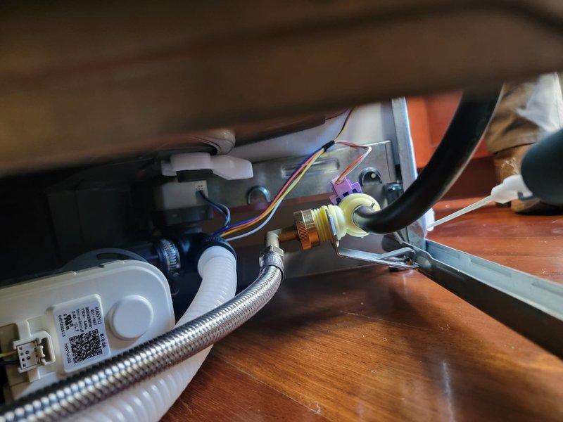 Responded to report of slow leak from dishwasher supply line. Upon inspection of under-sink plumbing, identified moisture at connection point between braided stainless steel supply line and dishwasher inlet valve. Tightened compression fitting at supply line connection and verified all associated plumbing connections for proper seal. Inspected drain assembly and P-trap configuration for any additional leak sources. Tested system by running dishwasher through fill cycle and monitored all connections for leaks. Confirmed repair successful with no active leaking present at completion.