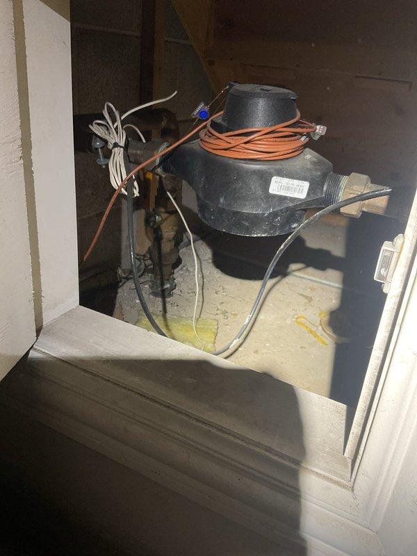 Responded to water leak originating from main bathroom and infiltrating into living room area. Upon investigation, identified active water damage evidenced by yellowish-brown discoloration and moisture staining on living room ceiling, with concentrated damage pattern along ceiling seam indicating sustained water intrusion from bathroom above. Traced leak source and documented damage extent including basement utility area where moisture penetration was affecting lower level structures. Photographed water-damaged ceiling surfaces showing linear staining patterns and discoloration, as well as basement conditions with visible floor staining near mechanical equipment and plumbing infrastructure.