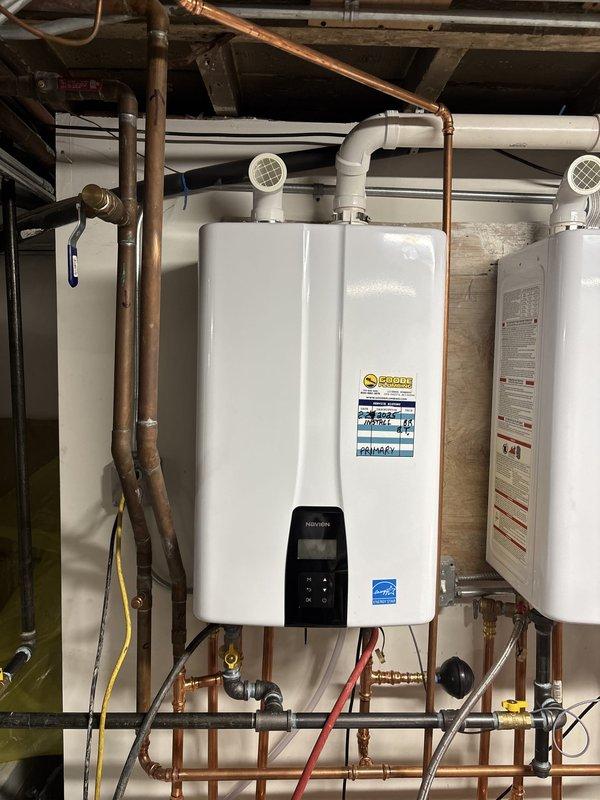 Performed scheduled maintenance on tankless water heater including draining and cleaning the inlet filter screen, which showed typical sediment accumulation. Verified all connections, tested system operation, and confirmed unit was functioning properly with no leaks or performance issues. Additionally inspected washing machine and dryer area in response to odor complaint; assessed drainage connections and ventilation systems for potential sources of the reported smell.