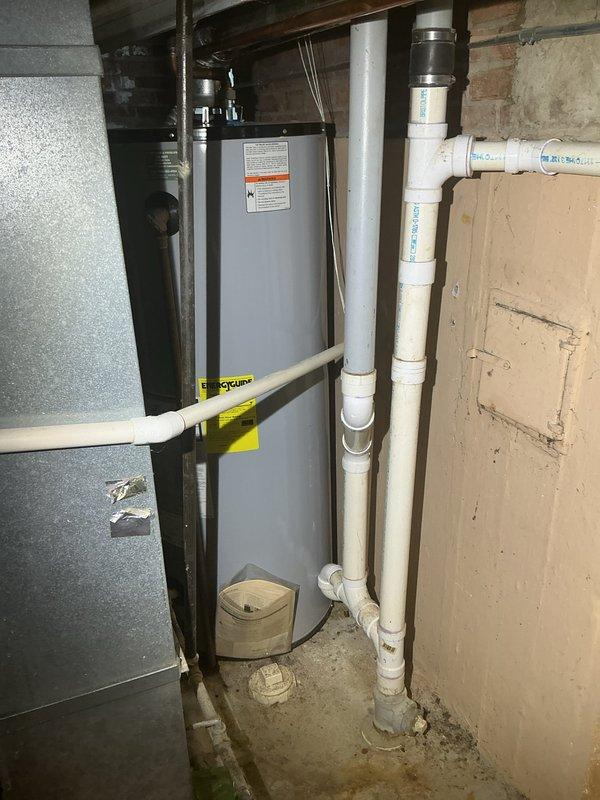 Completed assessment and sold repair for basement plumbing and HVAC system installation. Documented existing utility room configuration including furnace with QuickCURB installation platform, water heater, vertical PVC drainage piping with proper fittings and joints, and utility closet access with exposed plumbing infrastructure requiring service intervention. Down payment collected with scheduling arranged for complete repair execution.