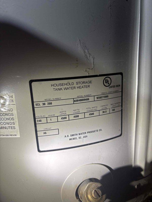 Responded to water intrusion complaint originating from unit above. Upon arrival, conducted thorough inspection of affected condo unit's plumbing systems and water heater installation. Examined A.O. Smith household storage tank water heater (Model AD040009488, Serial R2612877005) rated at 240V, 4500W for signs of leakage or failure. Inspected under-sink plumbing assembly including garbage disposal unit, P-trap configuration, and associated drain connections. Identified significant condensation buildup on insulated supply pipes beneath sink, with extensive moisture accumulation on grey-blue insulated horizontal pipe runs. Assessed all visible plumbing fixtures, connections, and fittings for active leaks or water damage. Documented conditions with photographic evidence showing water heater specifications and under-sink plumbing components. Determined that condensation on cold water supply lines was contributing to localized moisture but confirmed leak source required coordination with up