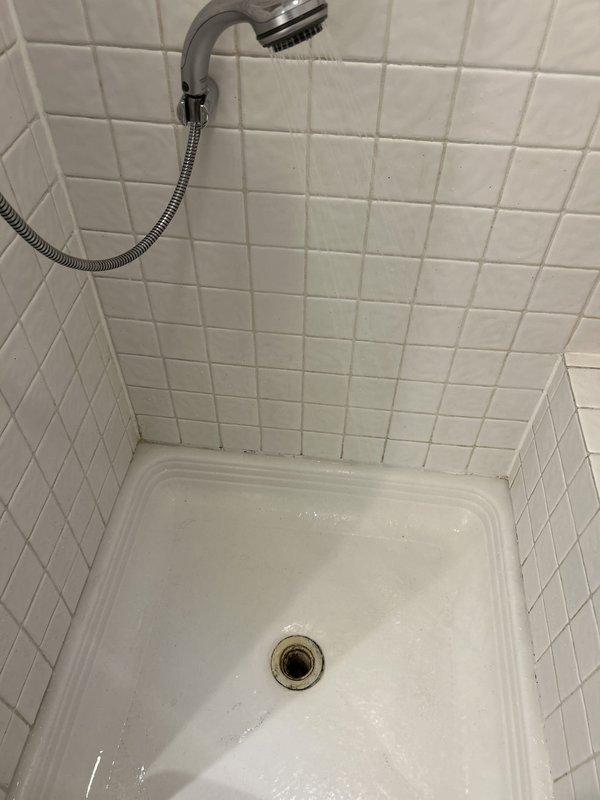Responded to complaint of water backing up in standing shower with visible debris. Upon arrival, found shower drain experiencing significant blockage with debris accumulation visible in both the shower pan and connected fixtures. Cleared obstruction from shower drain line using appropriate drain cleaning equipment. Removed accumulated debris and sediment that had caused the backup condition. Tested drainage flow to confirm proper operation and verified water now drains freely without backup. System restored to normal function.