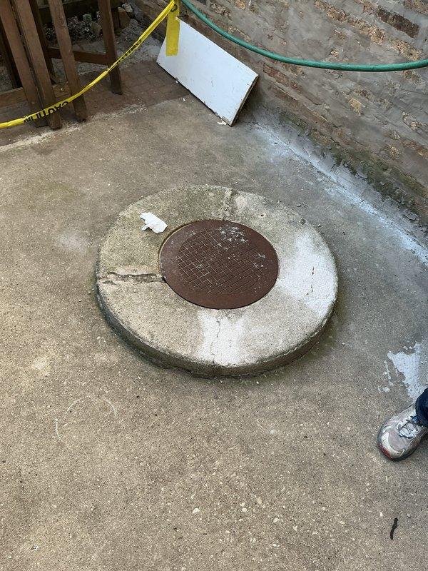Conducted on-site assessment of commercial catch basin system requiring replacement. Inspected existing catch basin with deteriorated manhole cover showing significant rust and corrosion, along with surrounding concrete surface exhibiting extensive cracking and weathering. Evaluated underground drainage pipes connected to the basin for structural integrity and determined replacement necessary. Documented current conditions through comprehensive photographic documentation of exterior catch basin location and interior access points where piping enters the structure. Prepared detailed estimate for complete catch basin replacement and associated piping infrastructure upgrades.