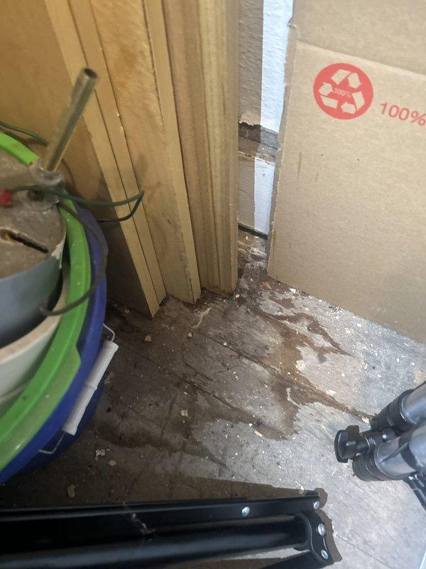 Responded to emergency water leak investigation affecting downstairs unit with ceiling water intrusion originating from upper unit plumbing system. Performed thorough inspection of exposed plumbing infrastructure, identifying aged plastic piping with visible deterioration, discoloration, and potential failure points at elbow joint connections. Documented compromised piping conditions and concrete floor staining consistent with active or recent water leakage in utility area.