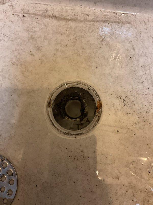 Responded to emergency call for backup issues affecting utility closet drain and mop sink. Upon arrival, found heavily stained mop sink with significant buildup around drain opening and visible debris accumulation within drain assembly. Assessed exposed plumbing infrastructure in utility area, including copper supply lines and chrome drainage components. Successfully cleared blockages causing backup in both fixtures, restoring proper drainage flow to utility closet drain system and mop sink. Documented existing condition of fixtures showing extensive wear, staining, and accumulated grime requiring future maintenance consideration.