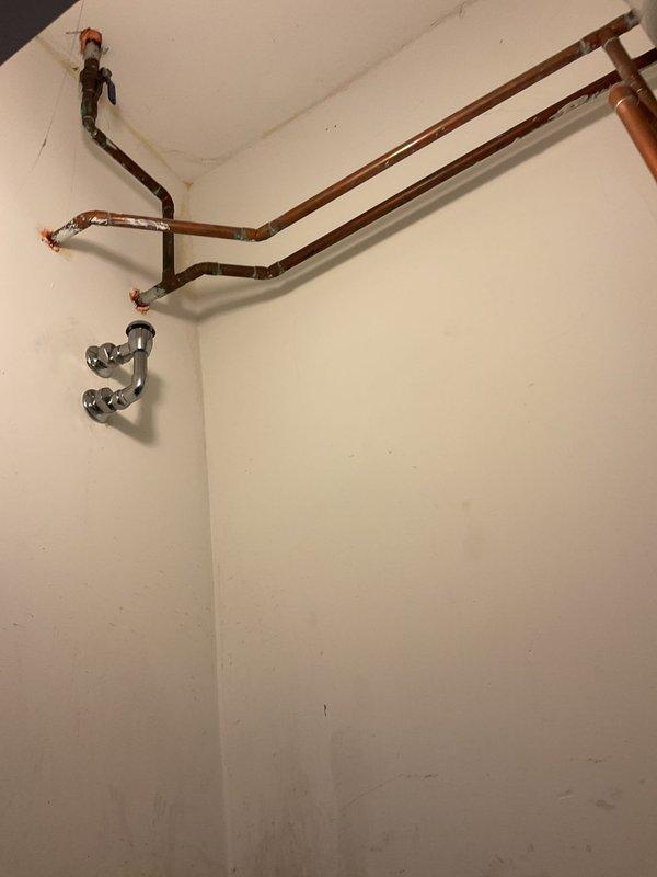 Responded to emergency call for backup issues affecting utility closet drain and mop sink. Upon arrival, found heavily stained mop sink with significant buildup around drain opening and visible debris accumulation within drain assembly. Assessed exposed plumbing infrastructure in utility area, including copper supply lines and chrome drainage components. Successfully cleared blockages causing backup in both fixtures, restoring proper drainage flow to utility closet drain system and mop sink. Documented existing condition of fixtures showing extensive wear, staining, and accumulated grime requiring future maintenance consideration.