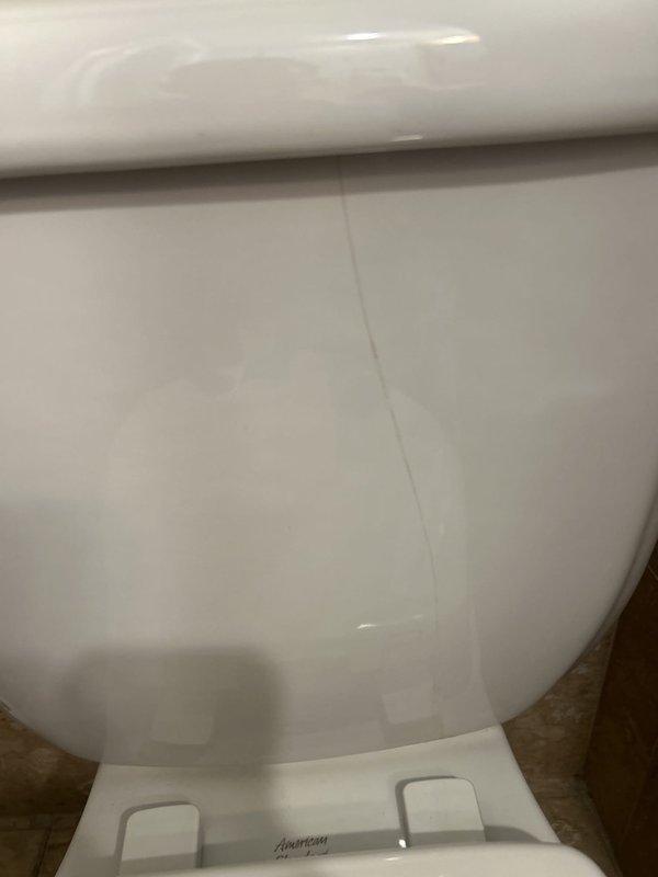 Responded to service call for leaking toilet caused by cracked tank. Performed on-site assessment of American Standard two-piece toilet to determine if tank replacement alone was feasible versus full toilet replacement. Documented existing conditions with photographs and advised customer that tank-only replacement options would be evaluated, with follow-up scheduled once replacement tank is procured.