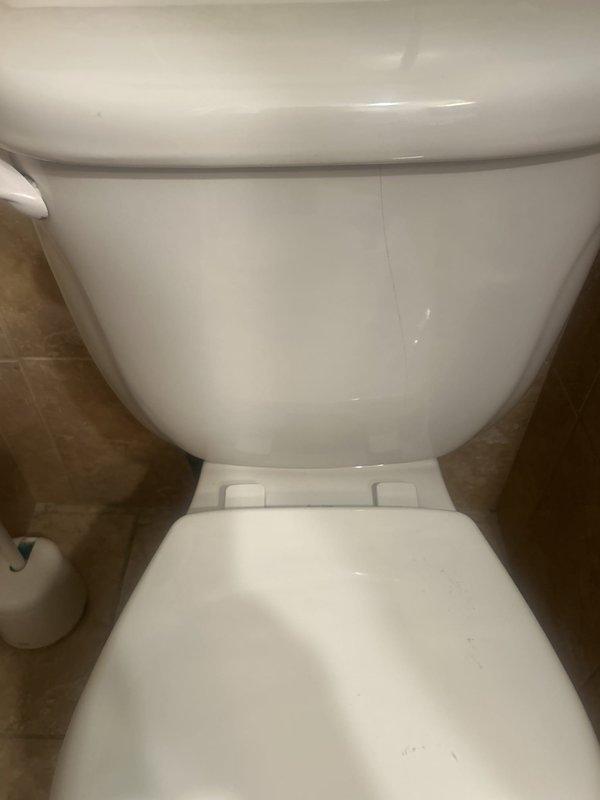 Responded to service call for leaking toilet caused by cracked tank. Performed on-site assessment of American Standard two-piece toilet to determine if tank replacement alone was feasible versus full toilet replacement. Documented existing conditions with photographs and advised customer that tank-only replacement options would be evaluated, with follow-up scheduled once replacement tank is procured.