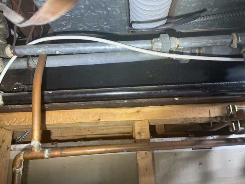 Responded to service call to locate existing water shut-off valves at residential property. Conducted thorough inspection of exterior and interior plumbing infrastructure, including examination of outdoor hose connections at brick wall perimeter and accessible piping in basement/crawl space area featuring copper supply lines and galvanized metal pipes. Provided estimate for installation of water shut-off valves as existing shut-offs could not be located on the property.