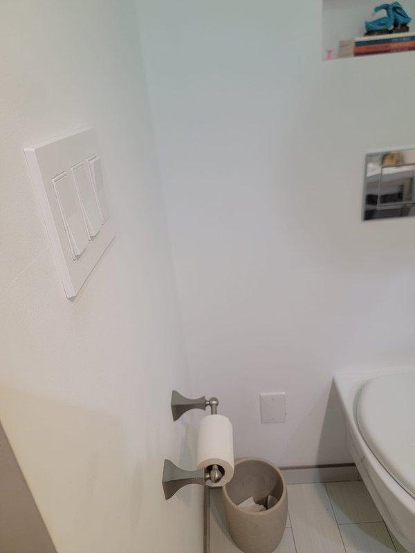 Responded to plumbing service call and completed repair work at residential property. Addressed underground pipe access point issue where copper piping connects to PVC conduit system embedded in concrete surface, and performed bathroom fixture maintenance including toilet paper holder and related bathroom accessories. Documentation photos captured for service records.