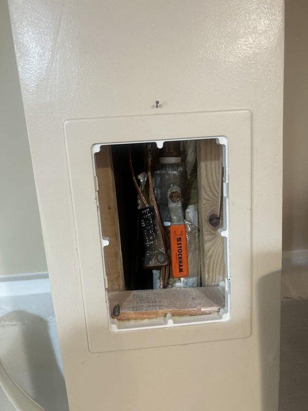 Accessed plumbing system through basement bedroom wall panel to address reported clogged drain issue. Inspected copper piping and drainage components within wall cavity, identified blockage point, and cleared obstruction to restore proper flow. System tested and confirmed operational upon completion.