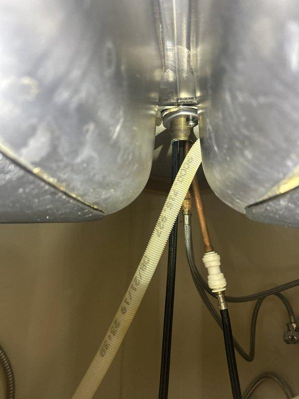 Responded to service call for reported shower head leak in bathroom. Upon arrival, contacted customer as requested and inspected the shower assembly. Examined chrome shower faucet fixture, tub spout, and surrounding white subway tile installation. Noted discoloration and staining along caulk line at tub-to-tile junction indicating moisture intrusion. Assessed plumbing connections and water supply lines. Completed necessary repairs to eliminate leak source. Verified proper operation of shower fixtures and confirmed no additional water seepage. No building-wide water shutoff was required for this repair.
