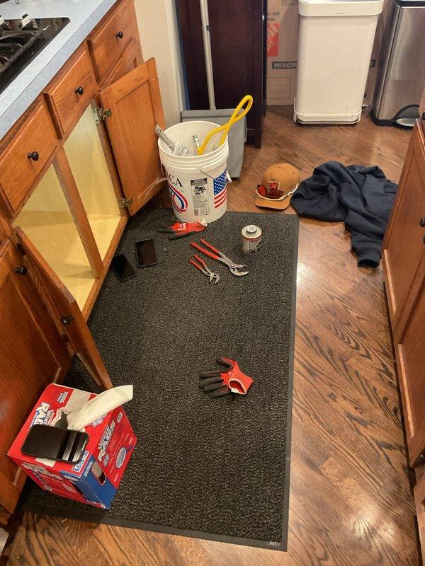 Installed gas pressure regulator and connected flexible CSST gas line to stove supply valve within utility cabinet. Verified proper valve operation and secure connections to ensure safe appliance functionality.