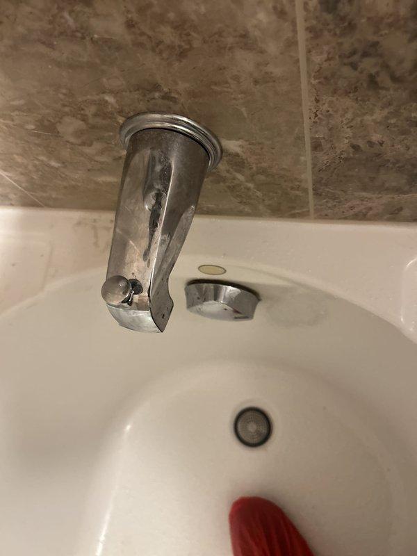 Responded to recurring faucet leak at bathroom sink for membership plan customer. Upon arrival, found deteriorated chrome-plated wall-mount spout with visible corrosion and finish degradation exposing underlying metal. Removed failed fixture and assessed wall-mounted copper supply pipe, which showed age-related patina but remained structurally sound. Provided on-site quote as requested, then proceeded with replacement of corroded spout assembly. Installed new chrome wall-mount faucet spout with proper escutcheon plate, ensuring secure connection to existing copper stub-out. Tested for leaks under full water pressure and verified proper flow rate and drainage. Documented conditions with photographs showing before and after states of installation.
