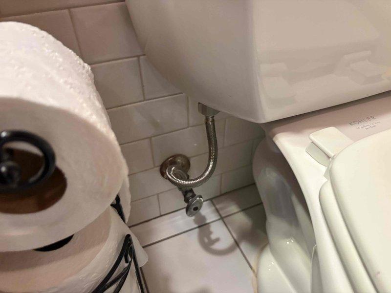 Responded to service call for two toilet issues in residential bathroom. Successfully cleared clog in first toilet using appropriate plumbing tools and techniques to restore proper drainage and flushing function. Inspected second Kohler toilet that was not filling properly and diagnosed issue with fill valve or water supply. Verified chrome braided supply line connection from wall-mounted shutoff valve to tank inlet was secure and functioning. Tested both toilets after repairs to confirm proper operation, adequate water flow, and complete tank filling. All fixtures returned to normal working condition.